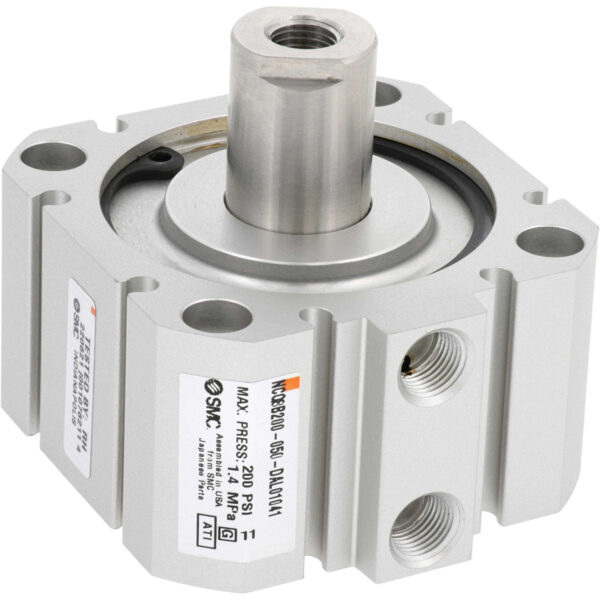 Grey rectangular pneumatic cylinder with four mounting through holes on each corner and two threaded holes on one of the sides. Part shown on white background.