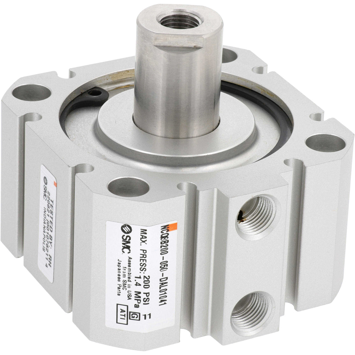 Grey rectangular pneumatic cylinder with four mounting through holes on each corner and two threaded holes on one of the sides. Part shown on white background.