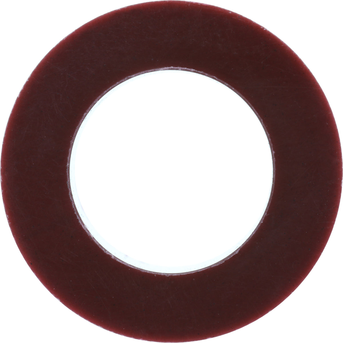 Burgundy colored plastic bushing on white background.