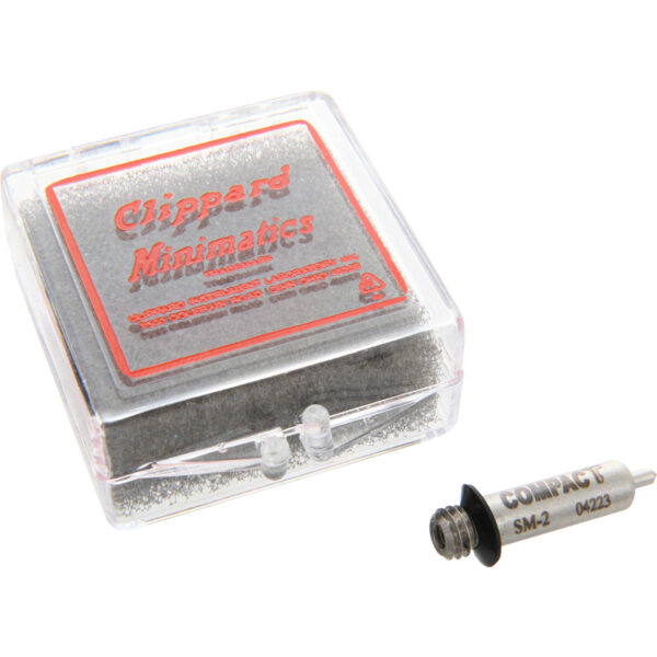 Single acting, spring return, sub-miniature pin cylinder sitting next to clear and red plastic case on white background. SM-2