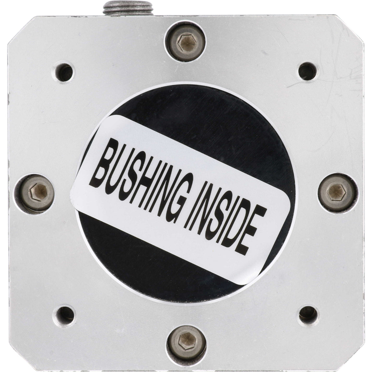Underside of grey gearbox with white sticker with black text that reads " bushing inside" on white background.